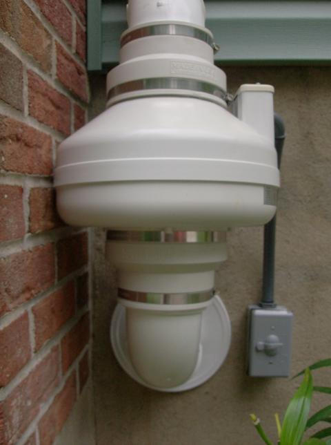 Close up of an exterior radon mitigation fan